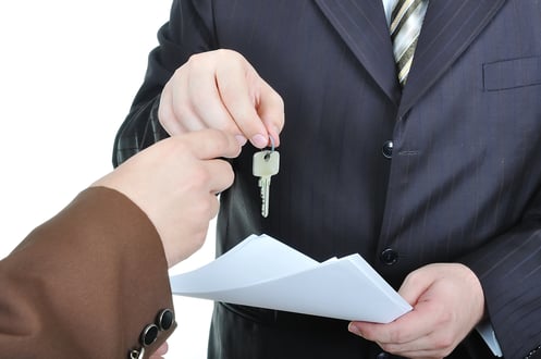 Two businessmen hands and the key, paper agreement